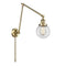 Beacon Swing Arm shown in the Antique Brass finish with a Clear shade