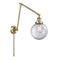 Beacon Swing Arm shown in the Antique Brass finish with a Clear shade