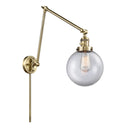 Beacon Swing Arm shown in the Antique Brass finish with a Clear shade