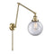 Beacon Swing Arm shown in the Antique Brass finish with a Clear shade