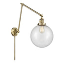 Beacon Swing Arm shown in the Antique Brass finish with a Seedy shade