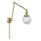 Beacon Swing Arm shown in the Antique Brass finish with a Seedy shade