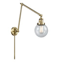 Beacon Swing Arm shown in the Antique Brass finish with a Seedy shade