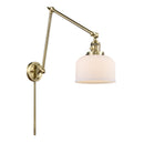 Bell Swing Arm shown in the Antique Brass finish with a Matte White shade