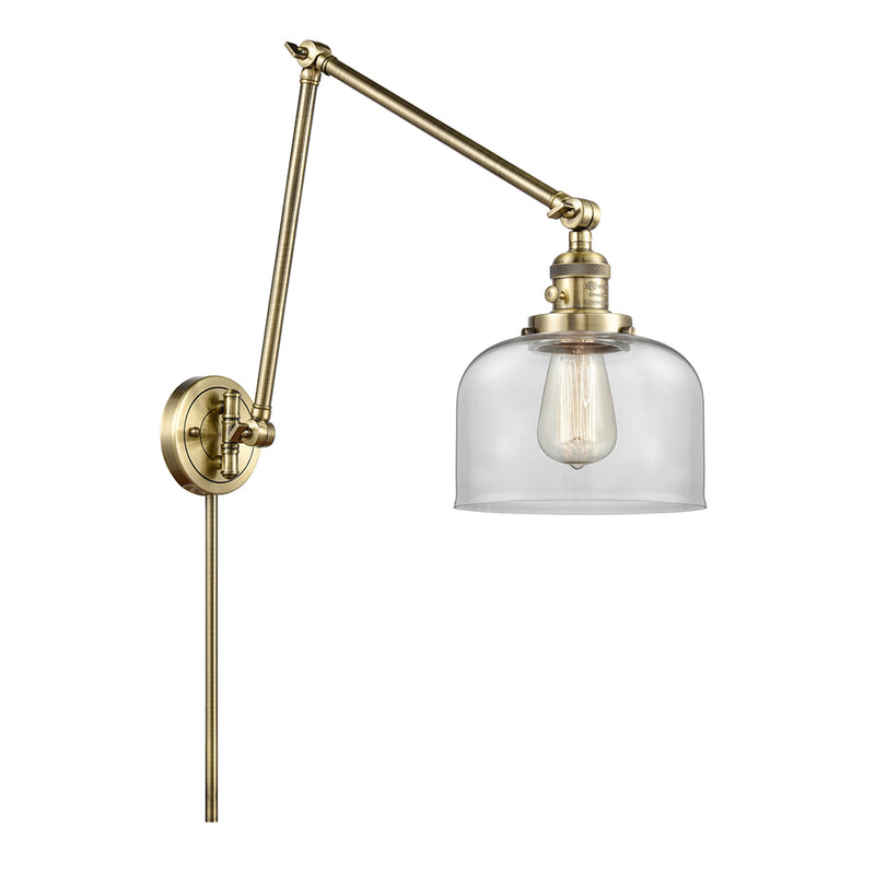 Bell Swing Arm shown in the Antique Brass finish with a Clear shade