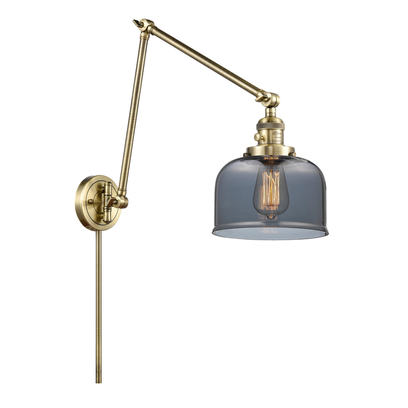 Bell Swing Arm shown in the Antique Brass finish with a Plated Smoke shade