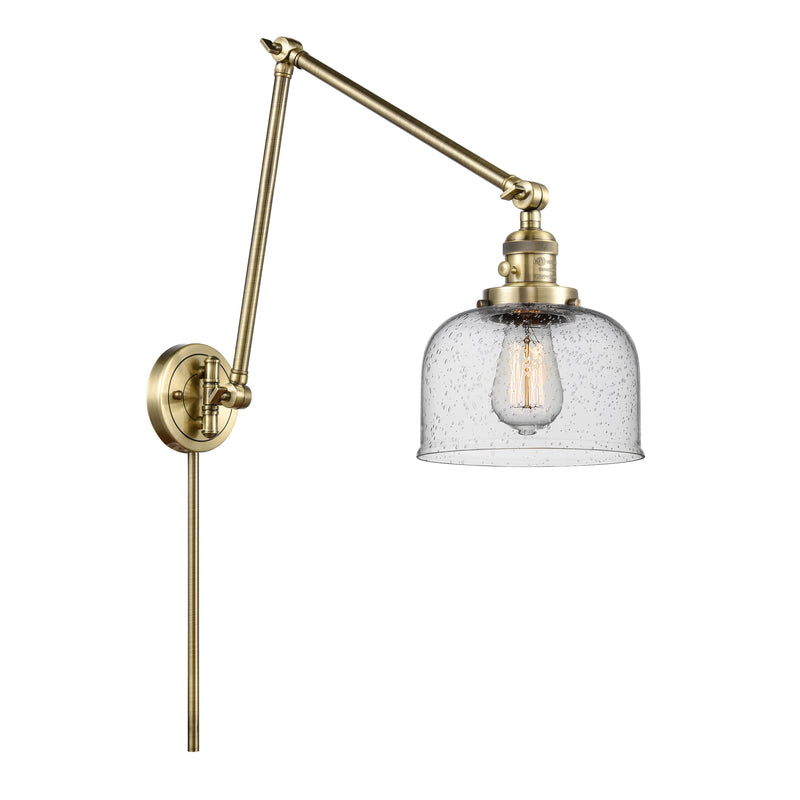 Bell Swing Arm shown in the Antique Brass finish with a Seedy shade