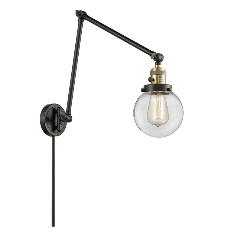 Beacon Swing Arm shown in the Black Antique Brass finish with a Clear shade