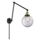 Beacon Swing Arm shown in the Black Antique Brass finish with a Clear shade