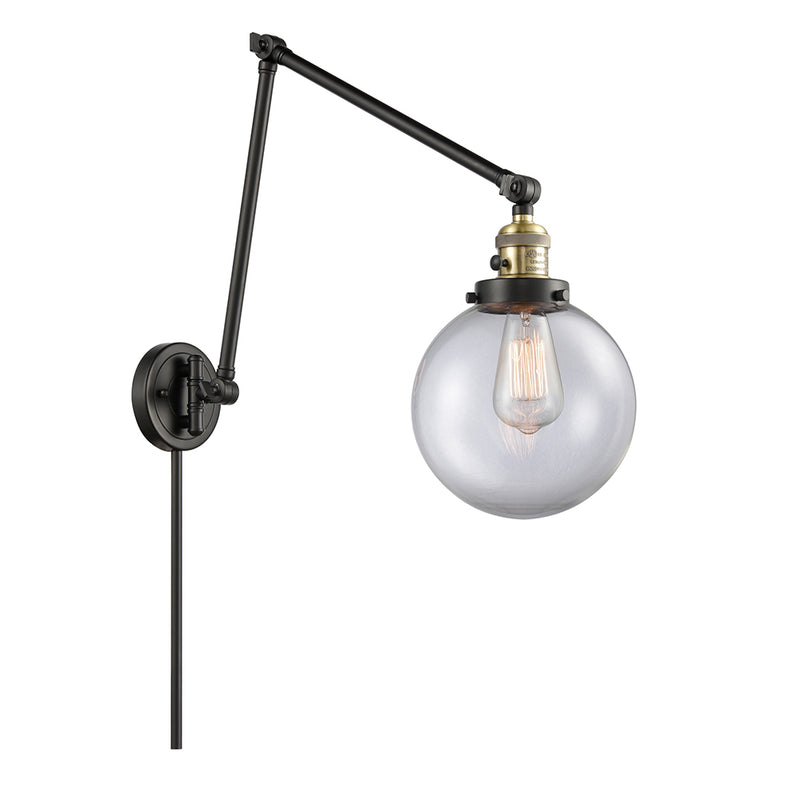 Beacon Swing Arm shown in the Black Antique Brass finish with a Clear shade