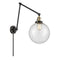 Beacon Swing Arm shown in the Black Antique Brass finish with a Seedy shade