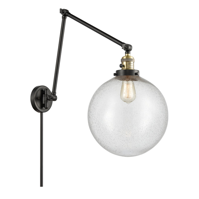 Beacon Swing Arm shown in the Black Antique Brass finish with a Seedy shade