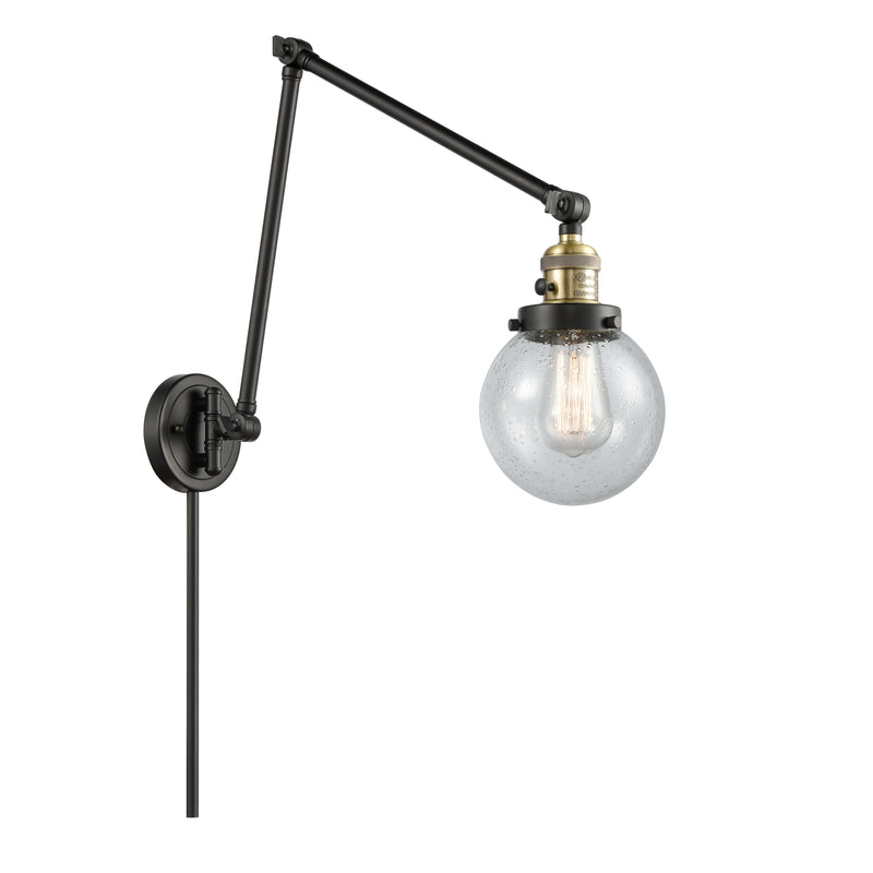 Beacon Swing Arm shown in the Black Antique Brass finish with a Seedy shade