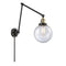 Beacon Swing Arm shown in the Black Antique Brass finish with a Seedy shade