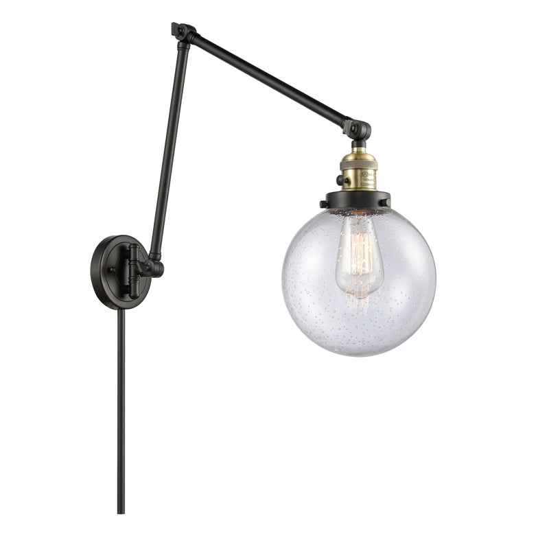 Beacon Swing Arm shown in the Black Antique Brass finish with a Seedy shade