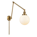 Beacon Swing Arm shown in the Brushed Brass finish with a Matte White shade