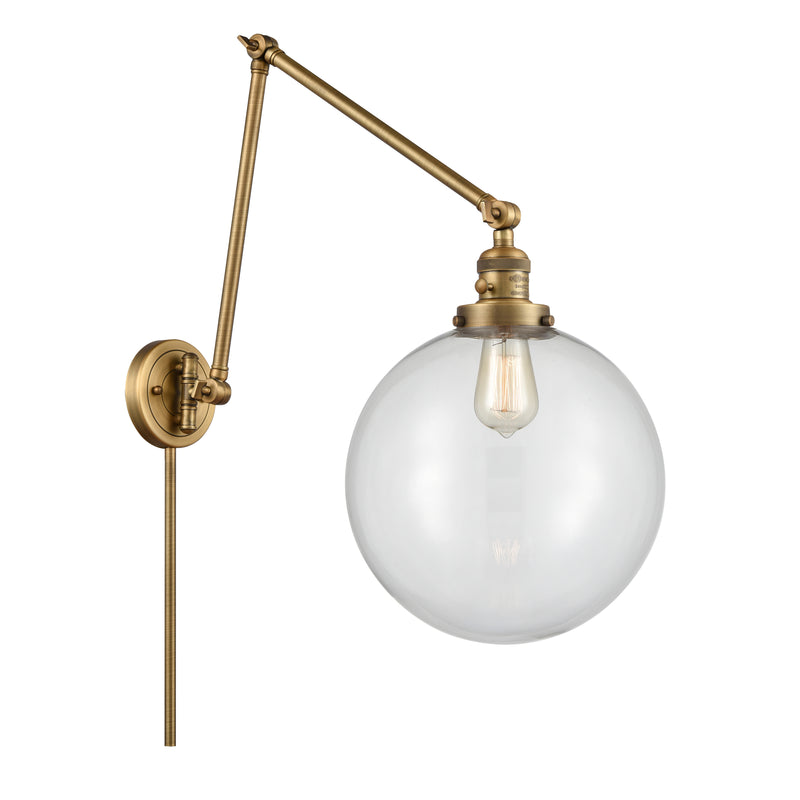 Beacon Swing Arm shown in the Brushed Brass finish with a Clear shade