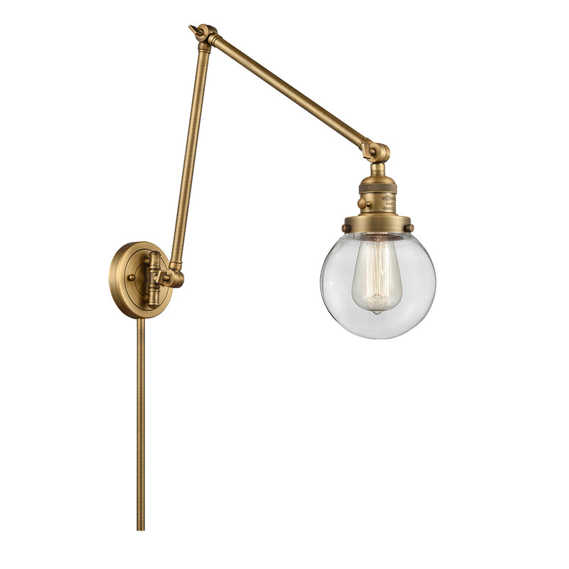 Beacon Swing Arm shown in the Brushed Brass finish with a Clear shade