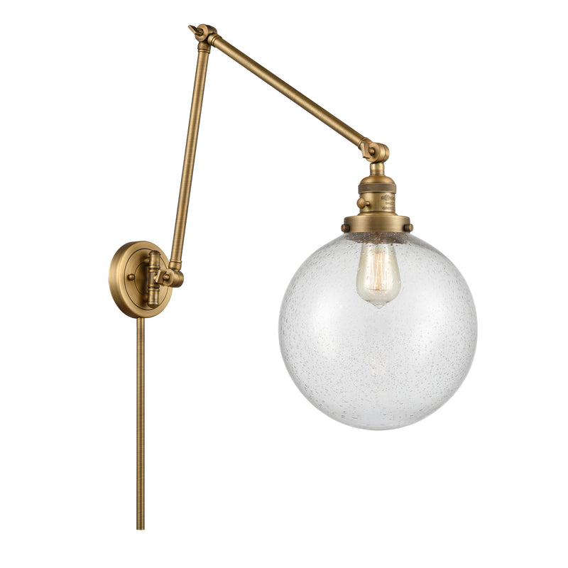 Beacon Swing Arm shown in the Brushed Brass finish with a Seedy shade