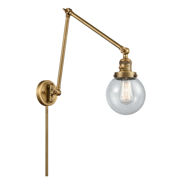 Beacon Swing Arm shown in the Brushed Brass finish with a Seedy shade