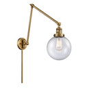 Beacon Swing Arm shown in the Brushed Brass finish with a Seedy shade