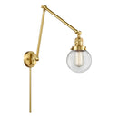 Beacon Swing Arm shown in the Satin Gold finish with a Clear shade