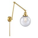 Beacon Swing Arm shown in the Satin Gold finish with a Seedy shade