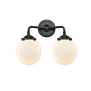 Beacon Bath Vanity Light shown in the Oil Rubbed Bronze finish with a Matte White shade