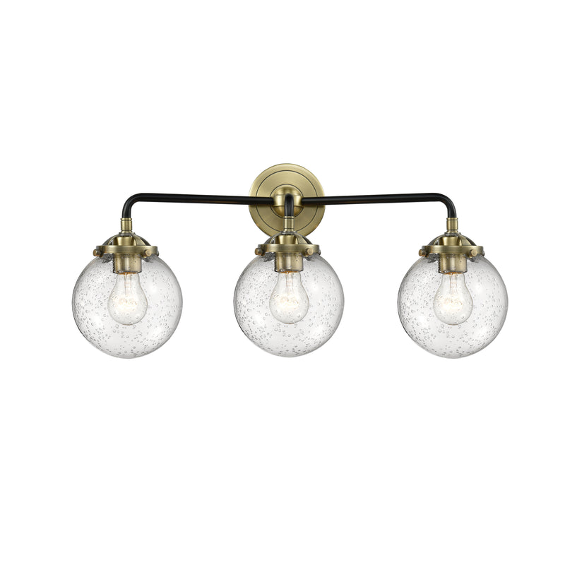 Beacon Bath Vanity Light shown in the Black Antique Brass finish with a Seedy shade