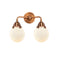 Beacon Bath Vanity Light shown in the Antique Copper finish with a Matte White shade