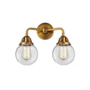 Beacon Bath Vanity Light shown in the Brushed Brass finish with a Clear shade