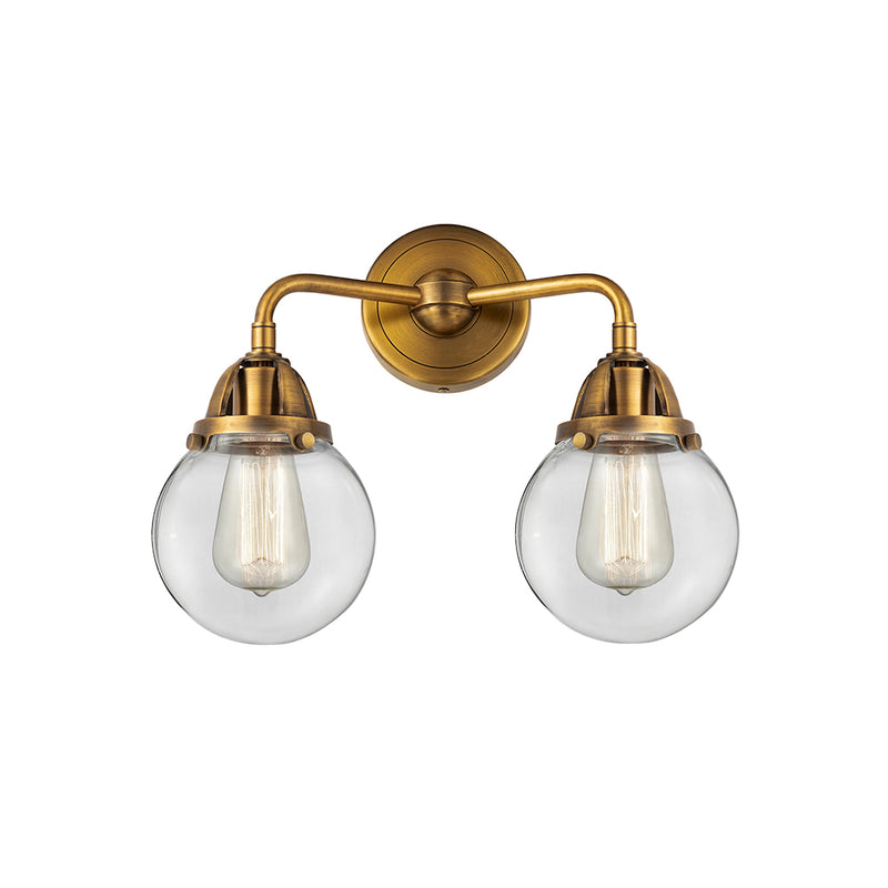 Beacon Bath Vanity Light shown in the Brushed Brass finish with a Clear shade