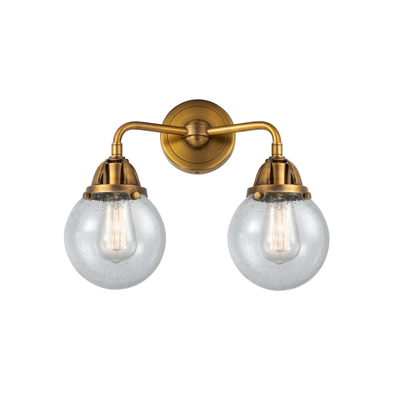 Beacon Bath Vanity Light shown in the Brushed Brass finish with a Seedy shade