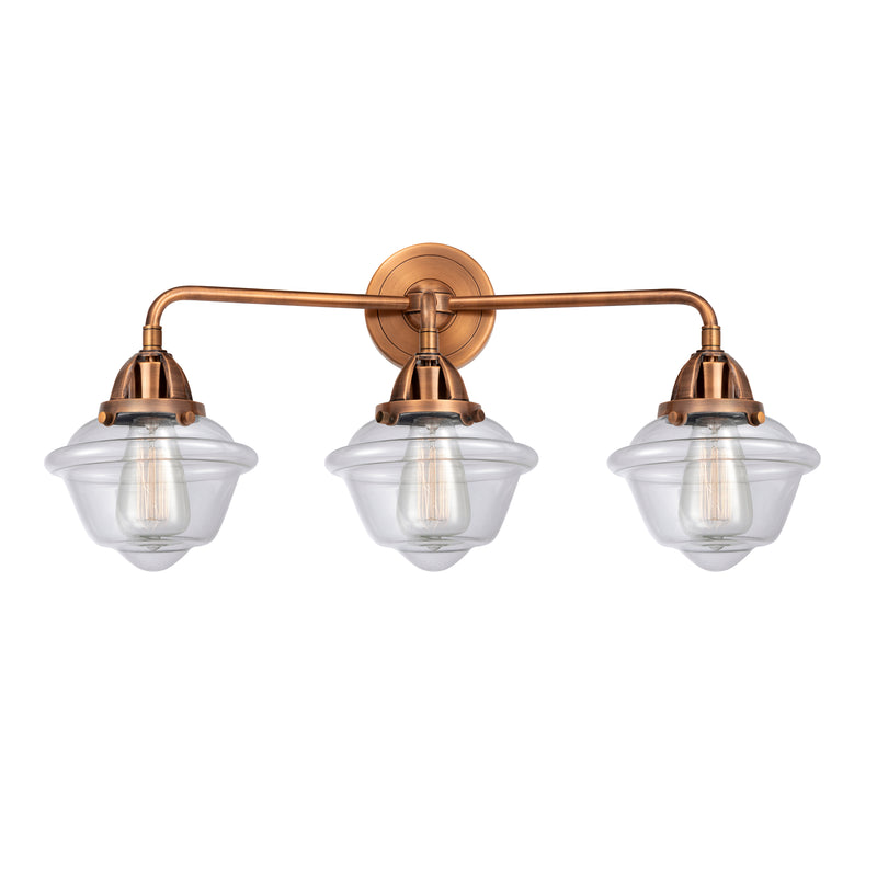 Oxford Bath Vanity Light shown in the Antique Copper finish with a Clear shade