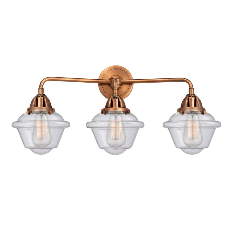 Oxford Bath Vanity Light shown in the Antique Copper finish with a Seedy shade