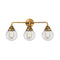 Beacon Bath Vanity Light shown in the Brushed Brass finish with a Clear shade