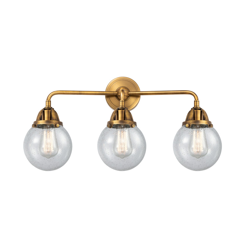 Beacon Bath Vanity Light shown in the Brushed Brass finish with a Seedy shade