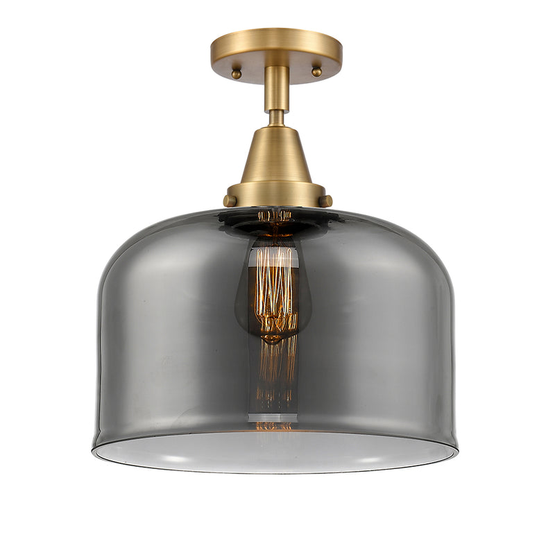 Bell Flush Mount shown in the Brushed Brass finish with a Plated Smoke shade