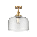 Bell Flush Mount shown in the Brushed Brass finish with a Seedy shade