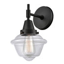 Caden Sconce shown in the Matte Black finish with a Clear shade