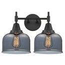 Caden Bath Vanity Light shown in the Matte Black finish with a Plated Smoke shade