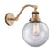 Beacon Sconce shown in the Brushed Brass finish with a Clear shade