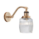 Colton Sconce shown in the Brushed Brass finish with a Clear Halophane shade