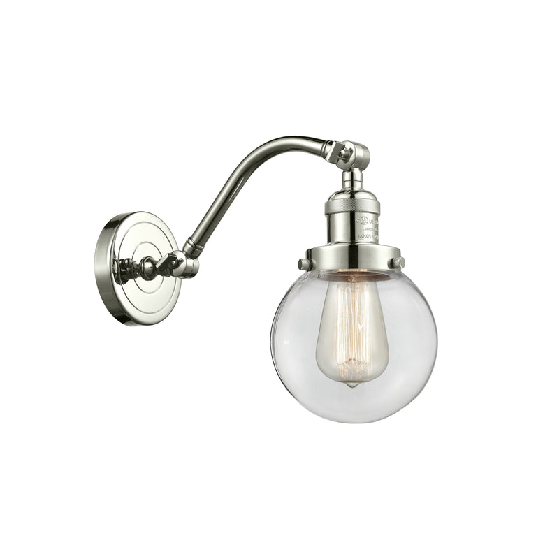 Beacon Sconce shown in the Polished Nickel finish with a Clear shade