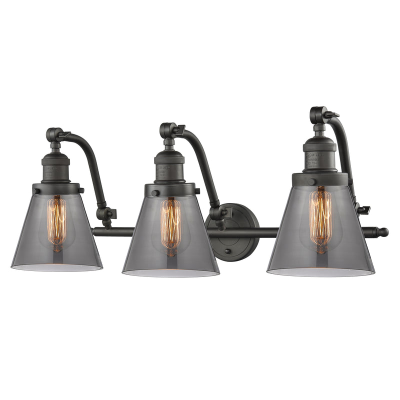 Cone Bath Vanity Light shown in the Oil Rubbed Bronze finish with a Plated Smoke shade