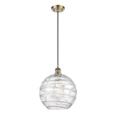 Deco Swirl Mini Pendant shown in the Antique Brass finish with a Clear shade