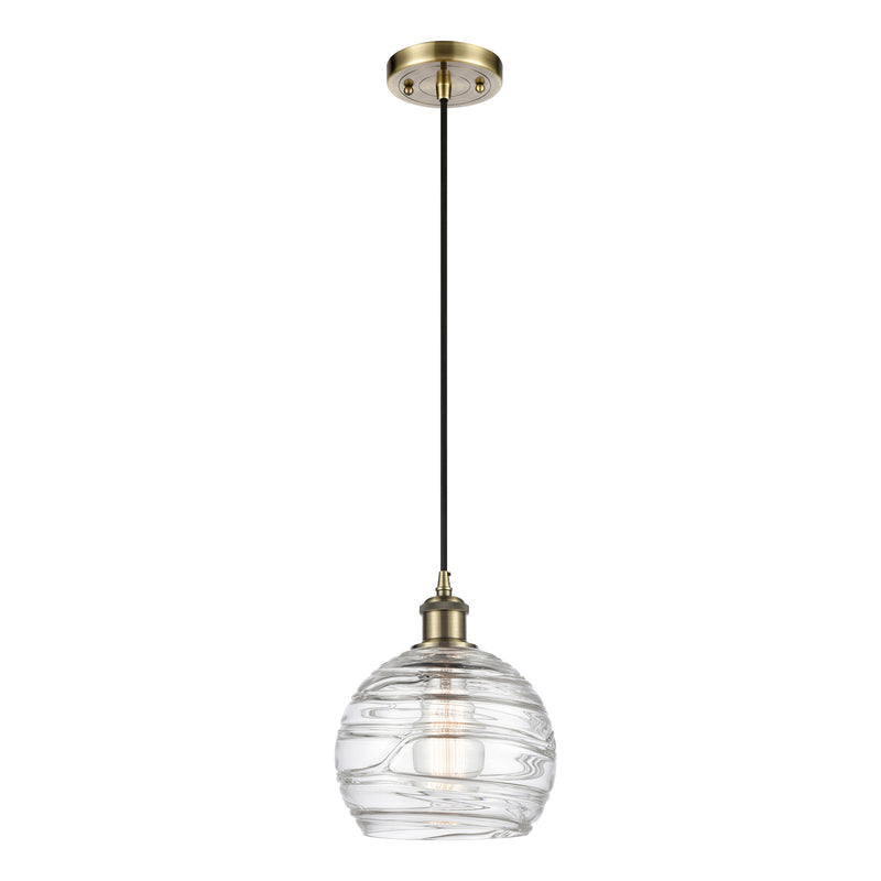 Deco Swirl Mini Pendant shown in the Antique Brass finish with a Clear shade