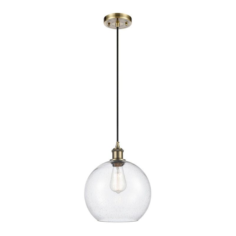 Athens Mini Pendant shown in the Antique Brass finish with a Seedy shade