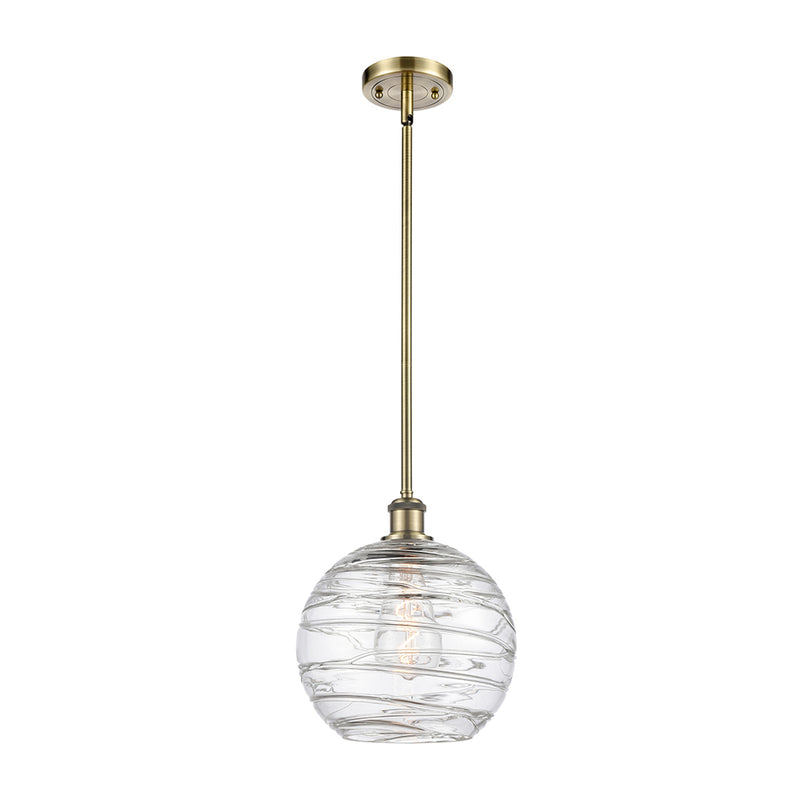 Deco Swirl Mini Pendant shown in the Antique Brass finish with a Clear shade