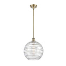 Deco Swirl Mini Pendant shown in the Antique Brass finish with a Clear shade